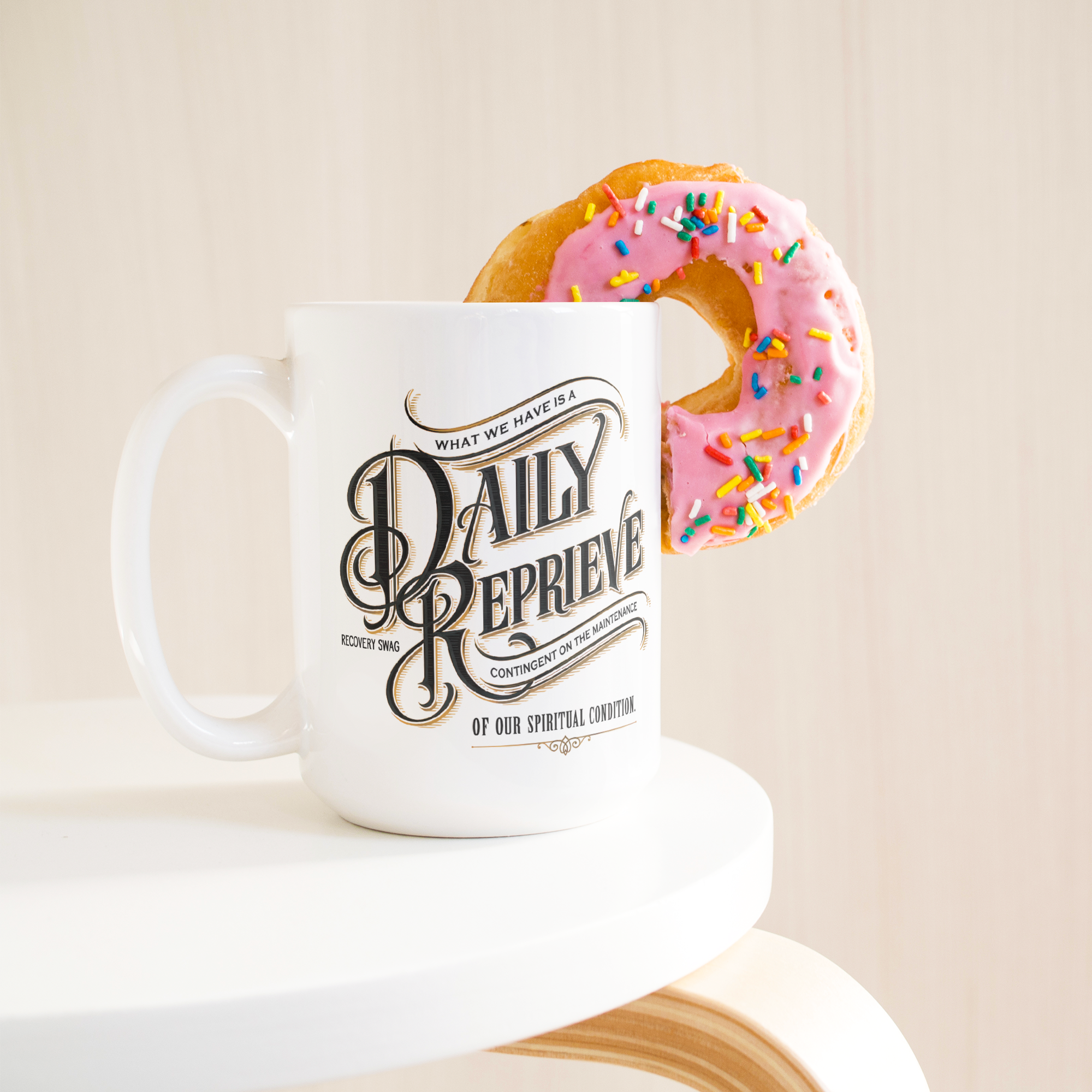 Daily_Reprieve_Recovery_Coffee_Mug__AA__15ozWhiteMugLifetsyleDonutLH_Mockup.png_15824921