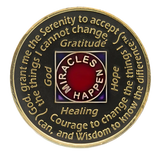 Back of black and red NA recovery medallion with the Serenity Prayer and Miracles Happen message