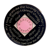 Back of pink NA recovery medallion with white crystals and Serenity Prayer