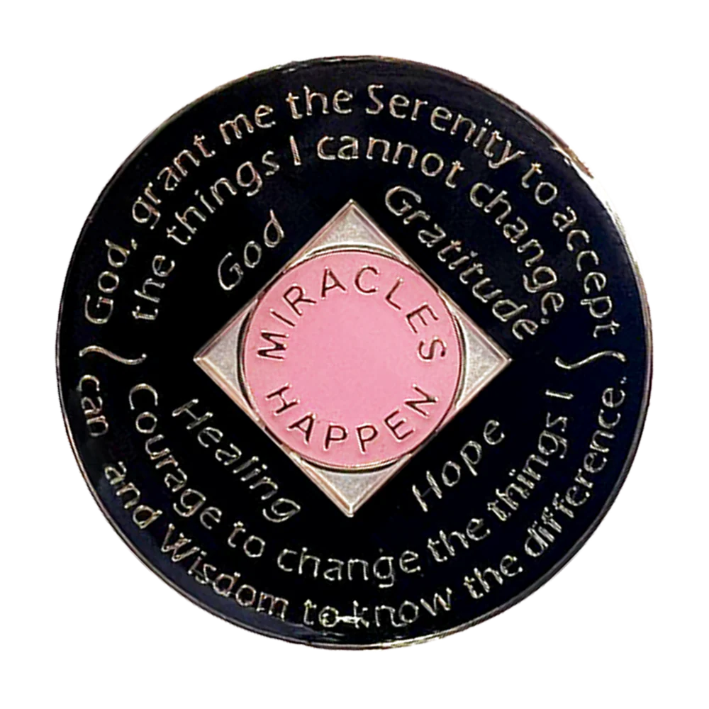 Back of pink NA recovery medallion with pink transition crystals and Serenity Prayer