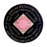 Back of pink NA recovery medallion with rainbow crystals and Serenity Prayer